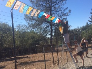hanging prayer flags on the fence